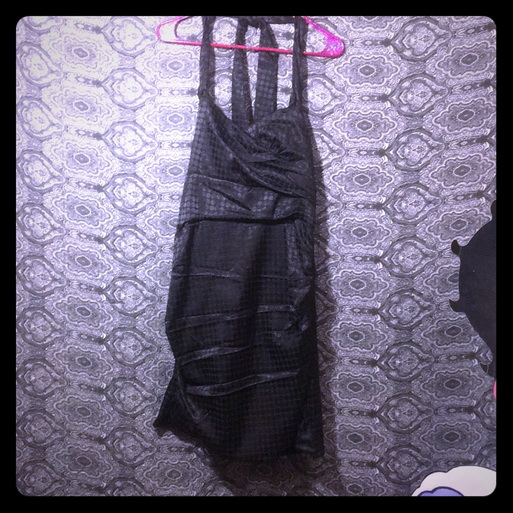 Black formfitting polkadot ties in the back dress.